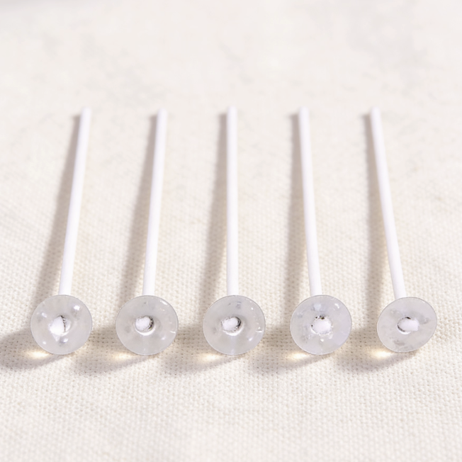 Cotton candle wicks with plastic bases, essential for candle making, providing a stable setup and clean burn for DIY candle projects