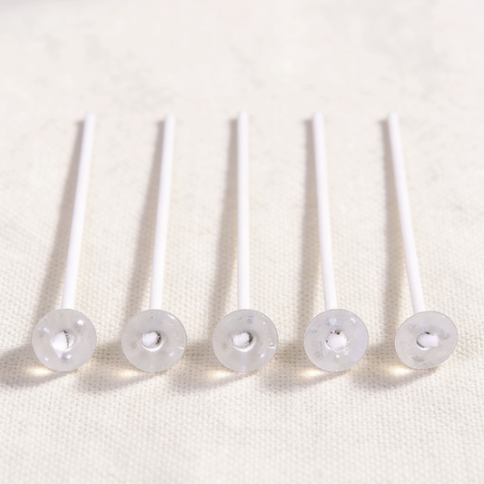 Cotton candle wicks with plastic bases, essential for candle making, providing a stable setup and clean burn for DIY candle projects