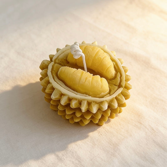 Durian-shaped candle with detailed flesh inside the spiky shell