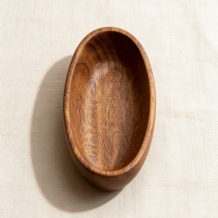 Oval-shaped wooden bowl with natural wood grain, ideal for holding candles, potpourri, or small decor items as a minimalist home accent