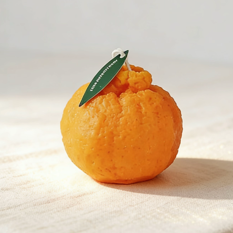 Realistic orange tangerine shaped decorative scented candle