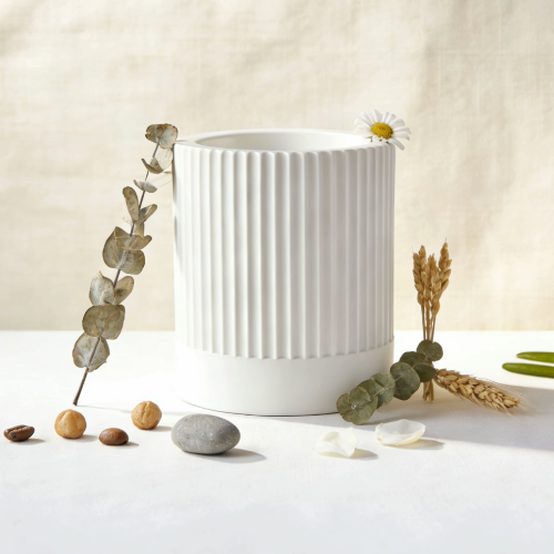 Ribbed candle jar with dried eucalyptus and natural decor
