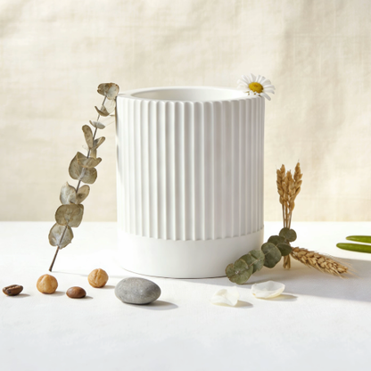 Ribbed candle jar with dried eucalyptus and natural decor
